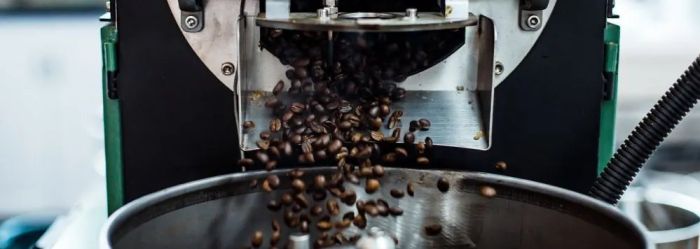 Freshly roasted coffee pouring from the roaster